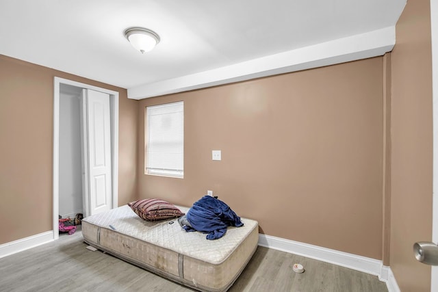 bedroom featuring hardwood / wood-style flooring and a closet