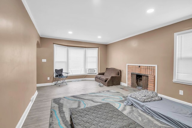 interior space featuring hardwood / wood-style floors, a fireplace, and crown molding