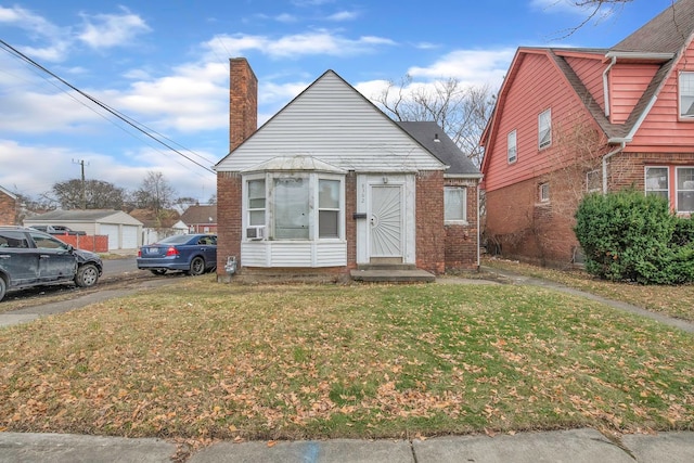 bungalow-style house with a front lawn