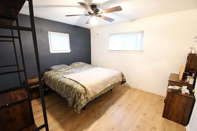 bedroom featuring multiple windows, ceiling fan, and light hardwood / wood-style floors