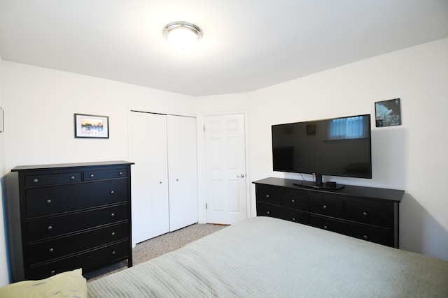 bedroom with a closet and light colored carpet