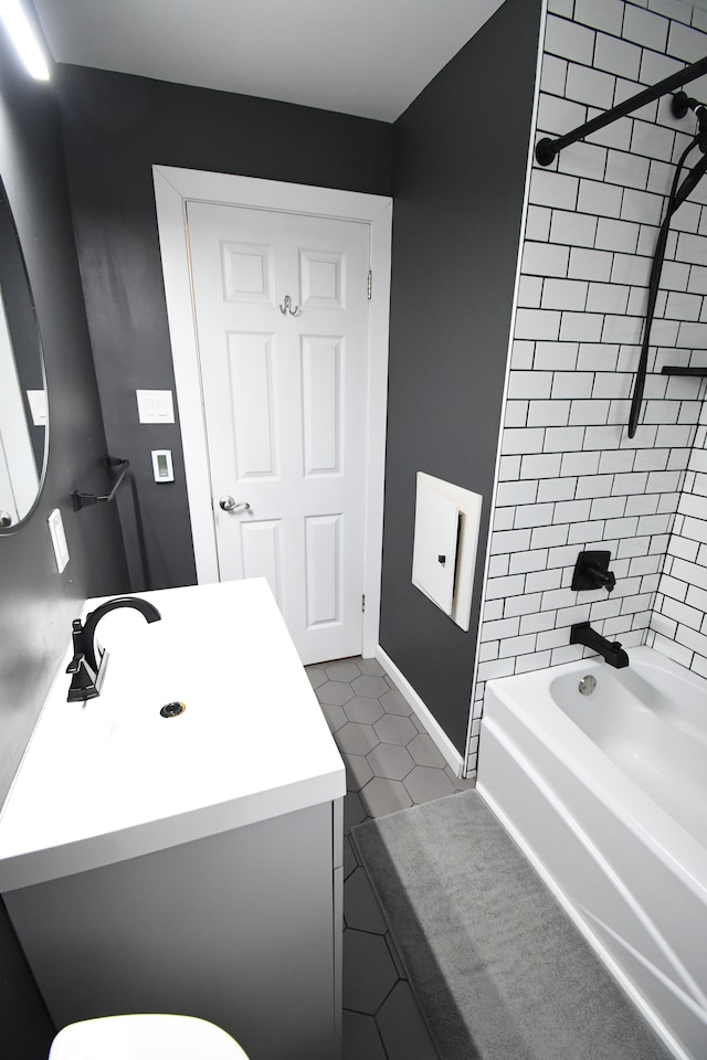 full bathroom with tile patterned flooring, vanity, toilet, and tiled shower / bath