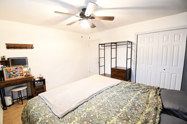 bedroom with ceiling fan, a closet, and light hardwood / wood-style flooring