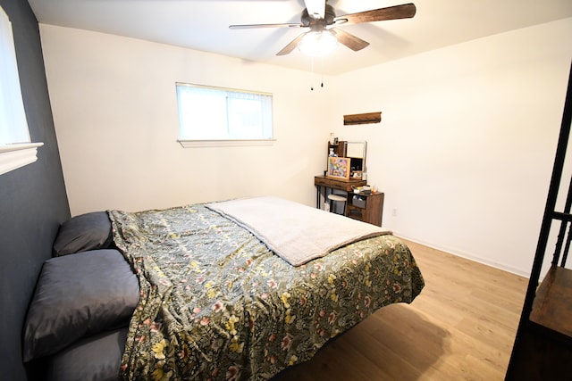 bedroom with ceiling fan and light wood-type flooring