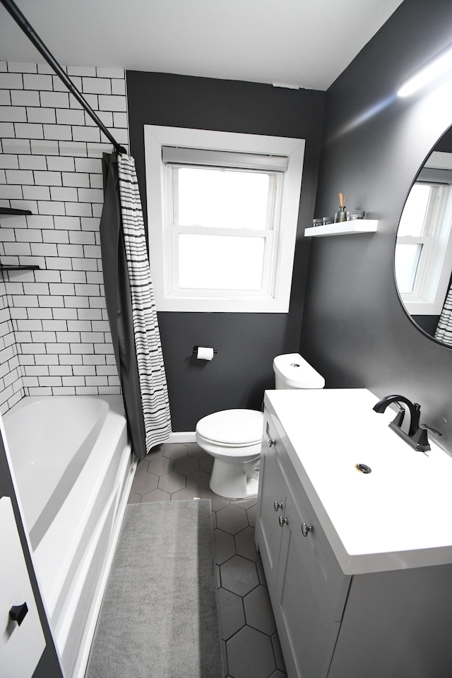 full bathroom featuring tile patterned floors, vanity, shower / tub combo, and toilet