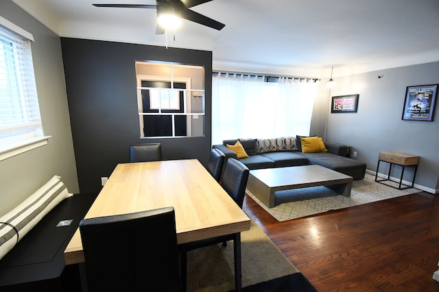 living room with ceiling fan and dark wood-type flooring