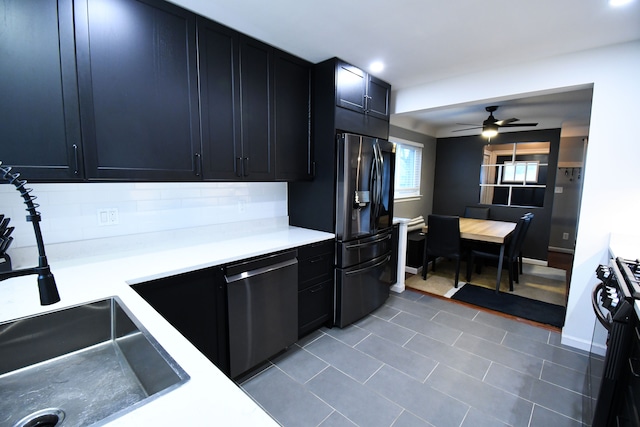 kitchen featuring decorative backsplash, stove, ceiling fan, fridge with ice dispenser, and dishwasher