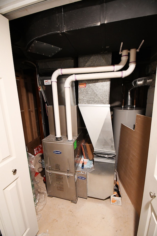 utility room featuring heating unit