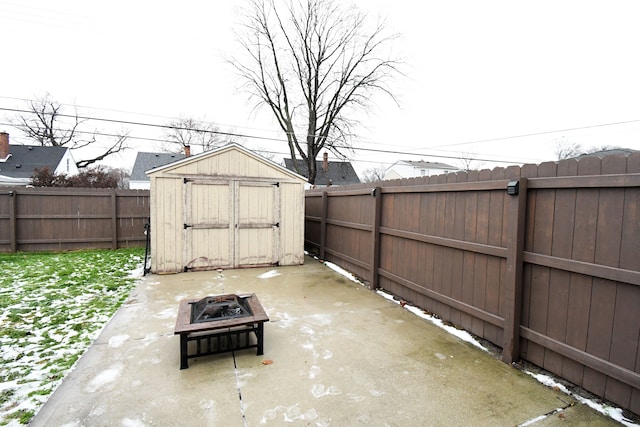 view of patio / terrace with a fire pit and a shed