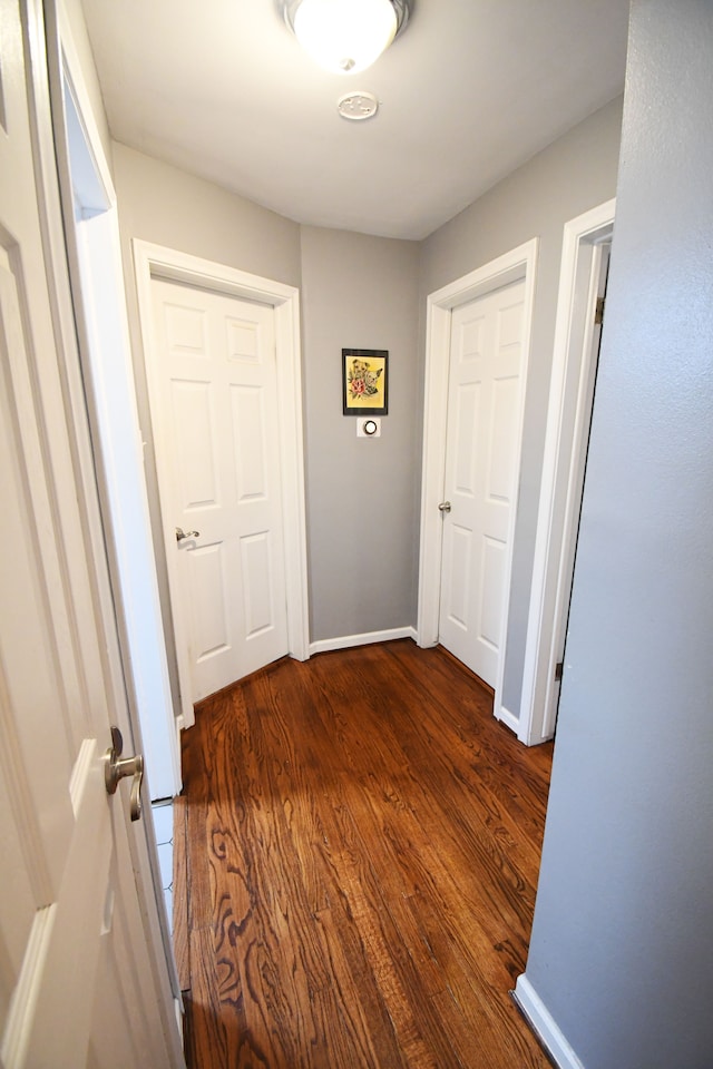 corridor with dark hardwood / wood-style floors