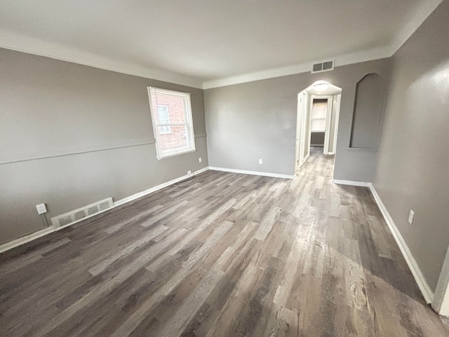 unfurnished room with dark wood-type flooring