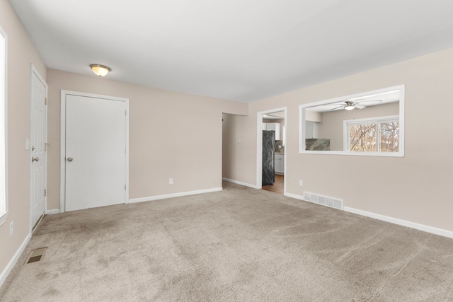 carpeted empty room with ceiling fan