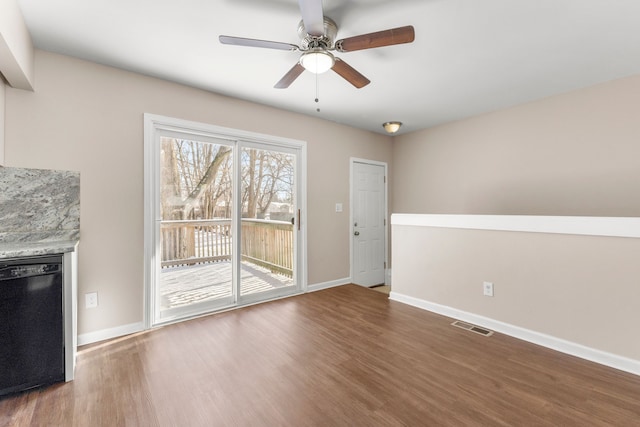 unfurnished living room with ceiling fan and dark hardwood / wood-style flooring