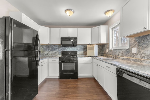 kitchen with tasteful backsplash, white cabinets, black appliances, and dark hardwood / wood-style floors