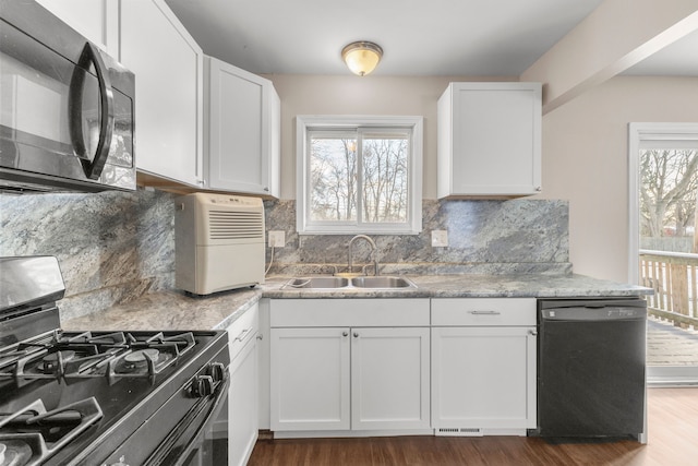 kitchen with white cabinets, sink, a wealth of natural light, and black appliances