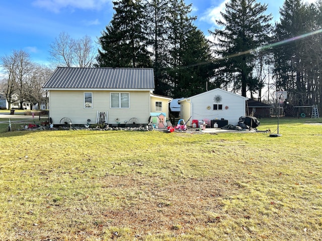 back of property with a lawn