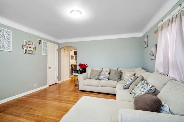 living room with hardwood / wood-style flooring and crown molding