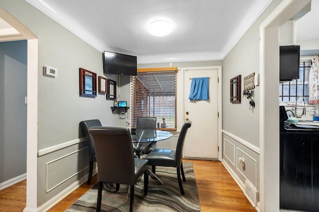 dining room featuring hardwood / wood-style floors and ornamental molding