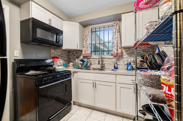 kitchen with sink, backsplash, white cabinetry, and black appliances