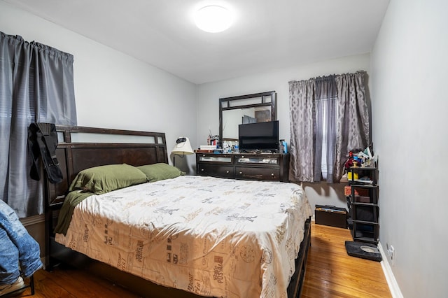 bedroom with hardwood / wood-style flooring