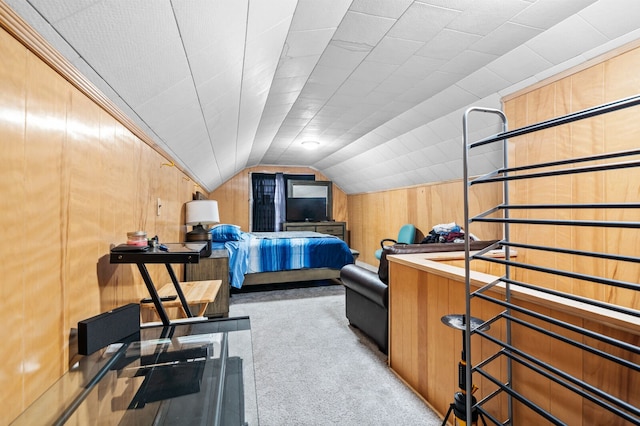 carpeted bedroom with lofted ceiling and wood walls