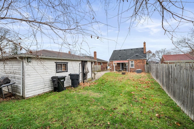 back of house with a lawn