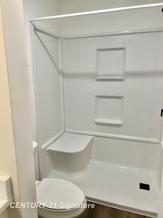 bathroom featuring toilet and walk in shower