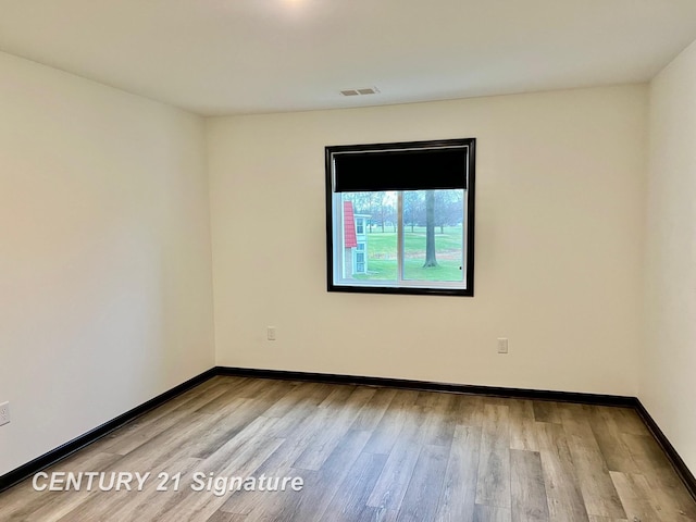 unfurnished room featuring light hardwood / wood-style floors