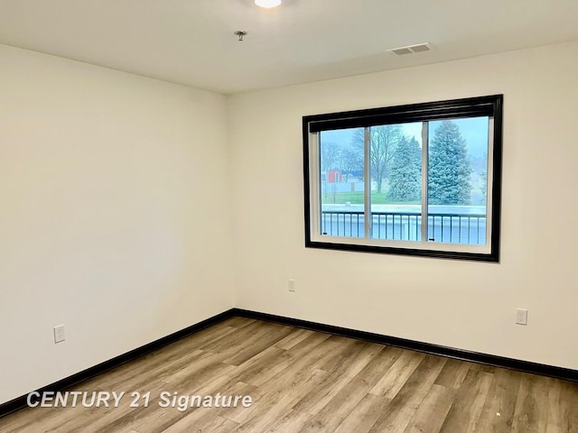 empty room with light hardwood / wood-style floors