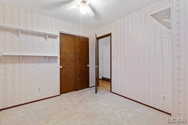 unfurnished bedroom featuring carpet flooring, ceiling fan, and a closet