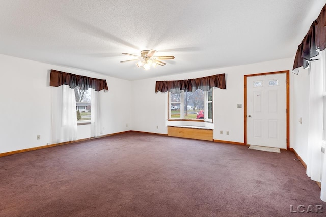 spare room featuring carpet flooring, ceiling fan, plenty of natural light, and a textured ceiling