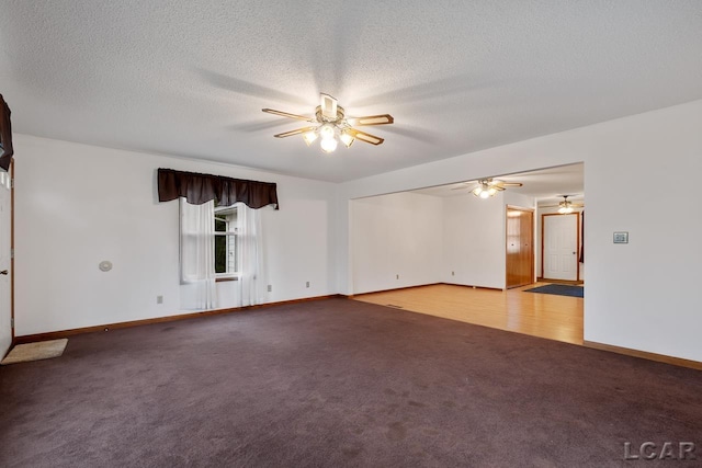 spare room with light colored carpet and a textured ceiling