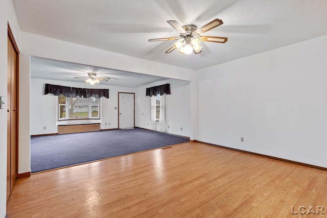 spare room featuring ceiling fan, a textured ceiling, and light hardwood / wood-style flooring