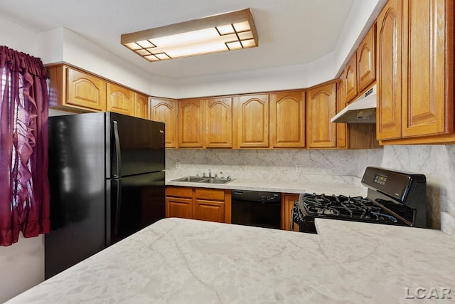 kitchen featuring decorative backsplash, sink, and black appliances