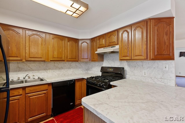 kitchen featuring black appliances, sink, and tasteful backsplash