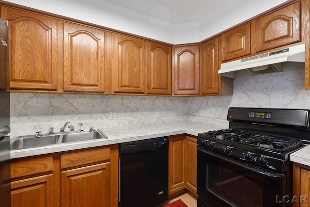 kitchen featuring tasteful backsplash, sink, and black appliances