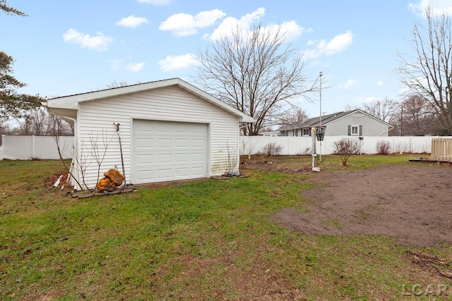 garage featuring a lawn