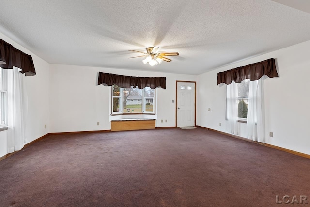 unfurnished living room with ceiling fan, carpet, and a textured ceiling