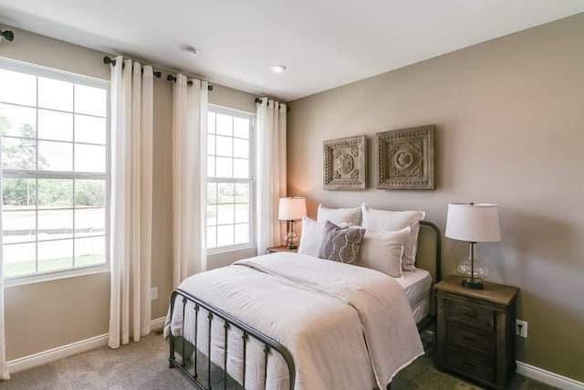 carpeted bedroom featuring baseboards