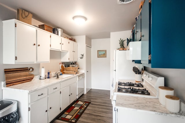 kitchen with white cabinets, sink, white appliances, and dark wood-type flooring