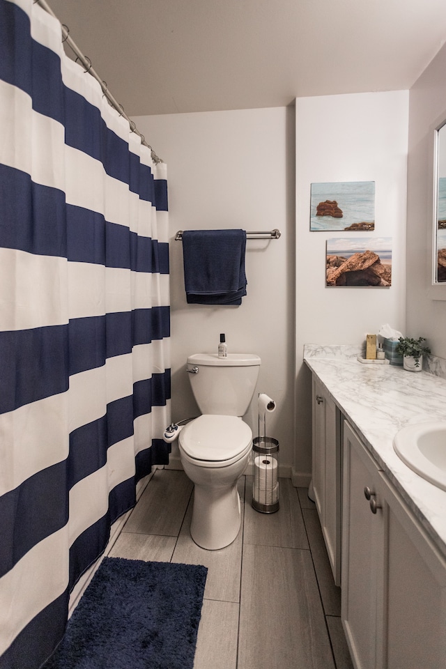 bathroom featuring toilet, vanity, and hardwood / wood-style flooring