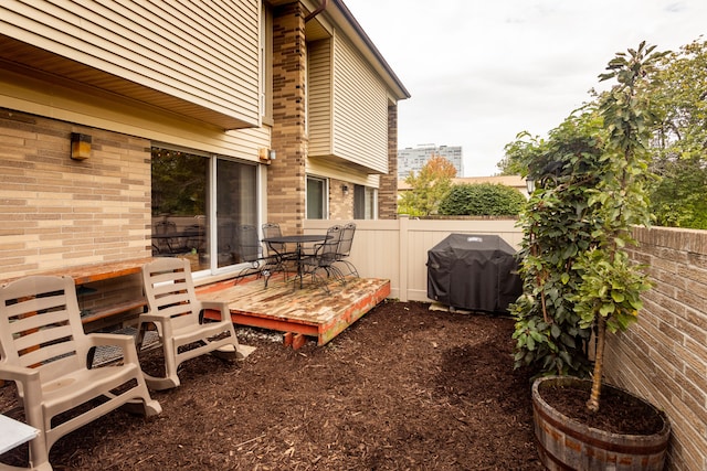 exterior space featuring a deck and a grill