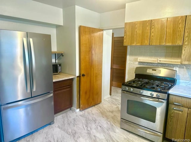 kitchen featuring backsplash and appliances with stainless steel finishes