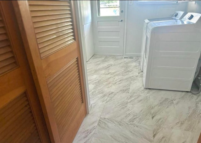 washroom featuring washer and clothes dryer