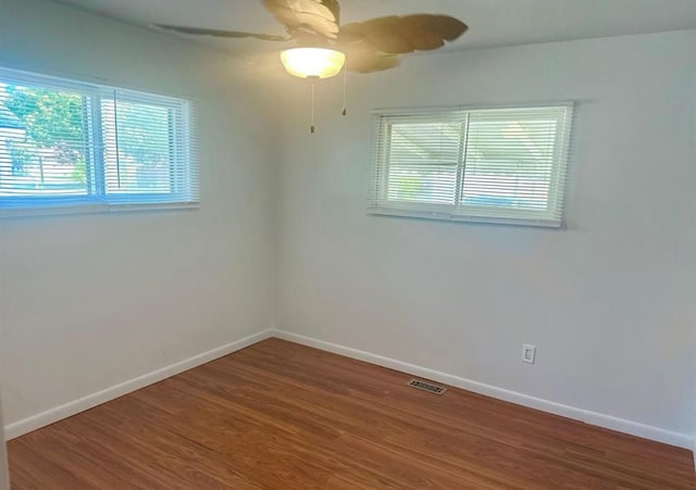 unfurnished room with hardwood / wood-style flooring and ceiling fan