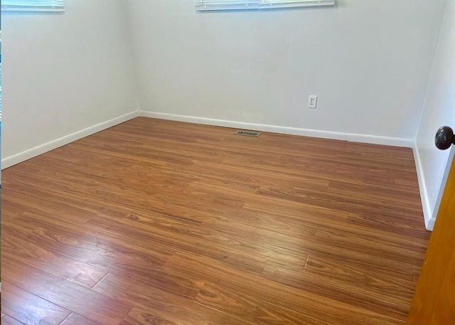 unfurnished room featuring hardwood / wood-style flooring