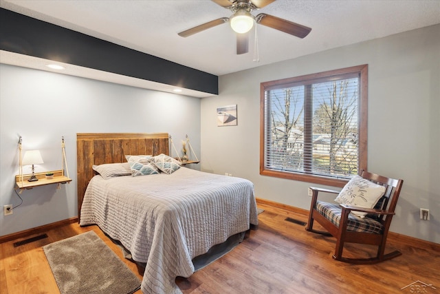 bedroom with ceiling fan and wood-type flooring