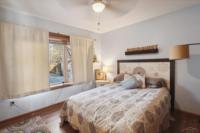 bedroom with dark hardwood / wood-style floors and ceiling fan