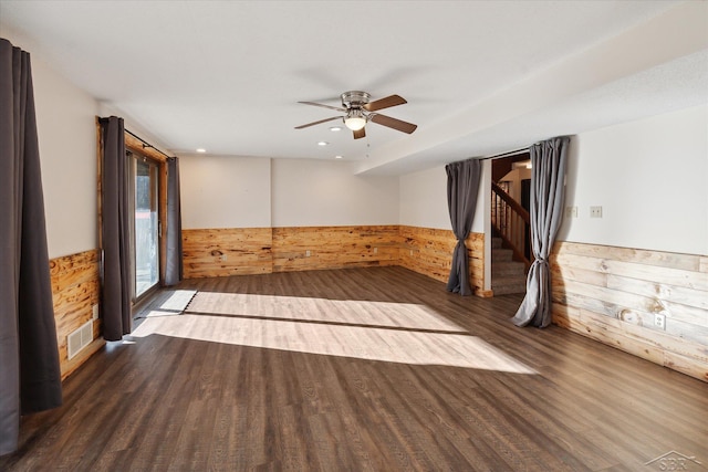 empty room featuring ceiling fan and dark wood-type flooring