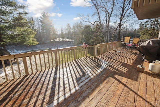 deck with a water view and grilling area